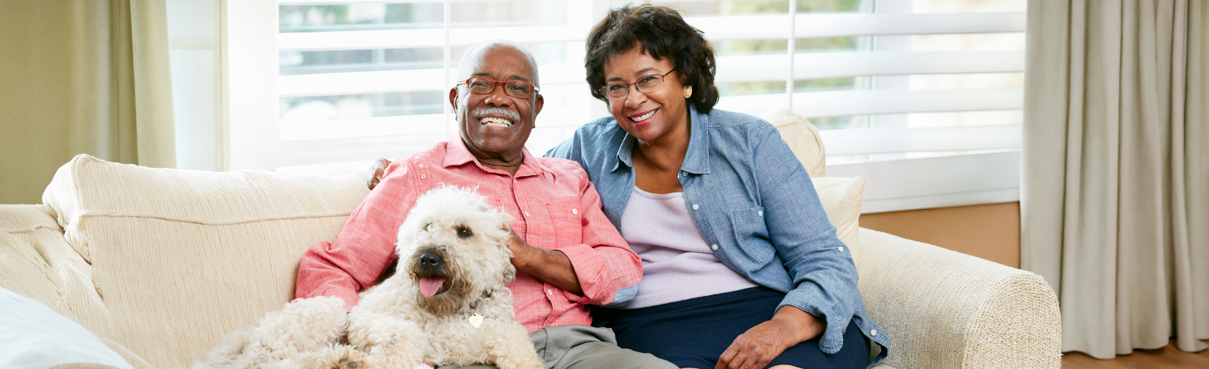 Two clients on couch with dog